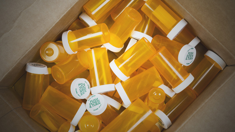 a box filled with prescription pill bottles