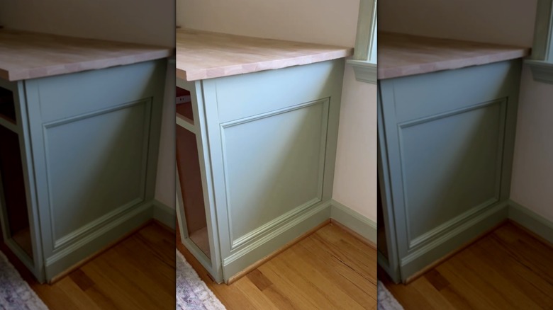 A green DIY kitchen cabinet molding job