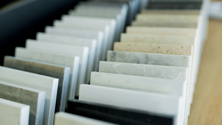 A close up of stone samples for countertops laying on their sides.