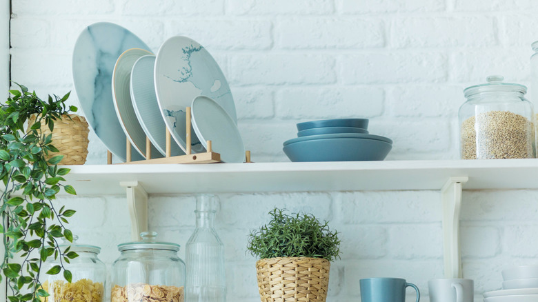 Dress Up Bland Open Shelving With A Creative Towel Bar Trick