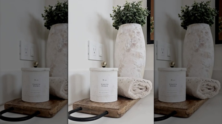 A bathroom counter with a DIY container
