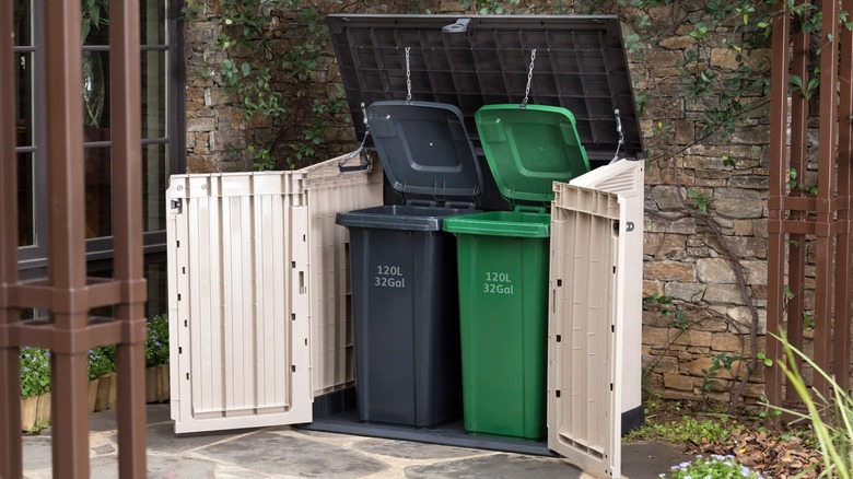 Open Keter Store-It-Out Midi Storage Shed with two trash bins inside