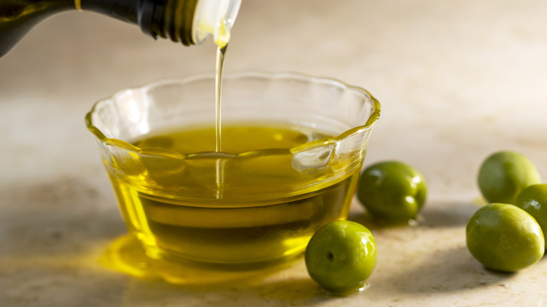 Oil being poured into a bowl
