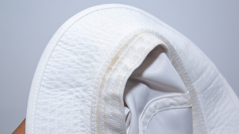Underside of a hat with sweat stains on the band