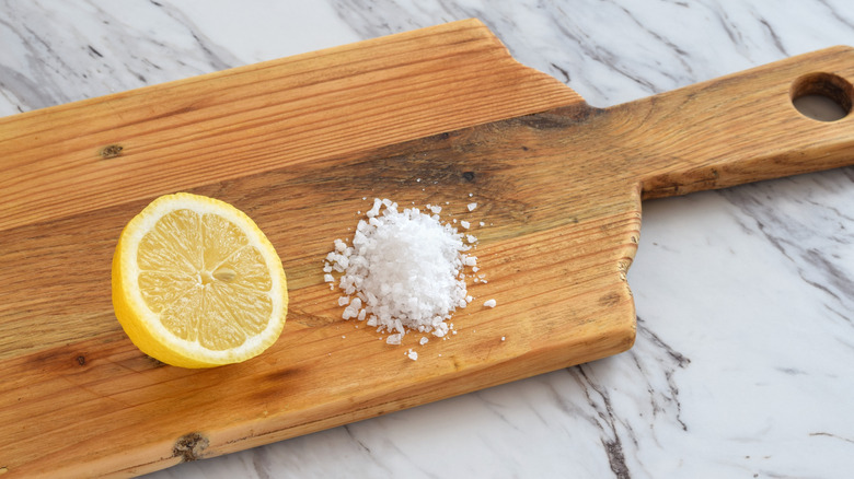 lemon and salt on a cutting board to prep for stain removal