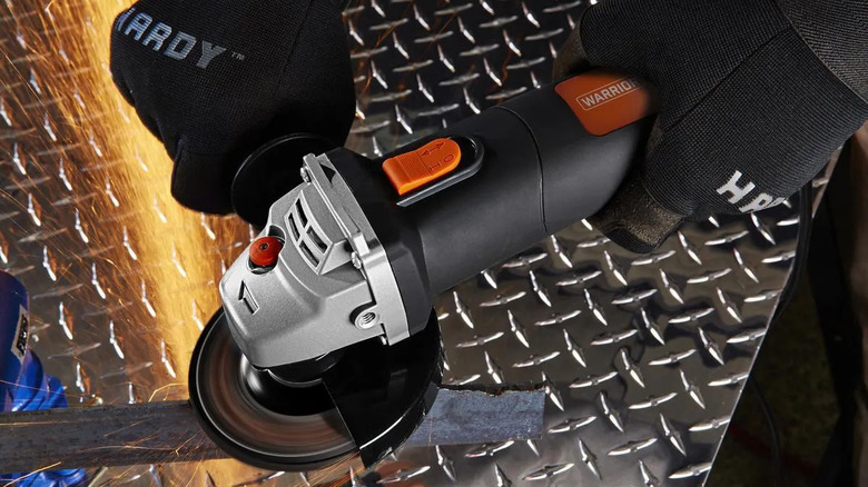 Sharpening a mower blade with a Warrior angle grinder from Harbor Freight.