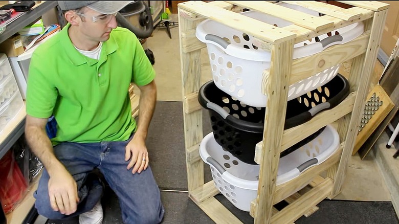 Person sitting next to completed DIY laundry basket organizer