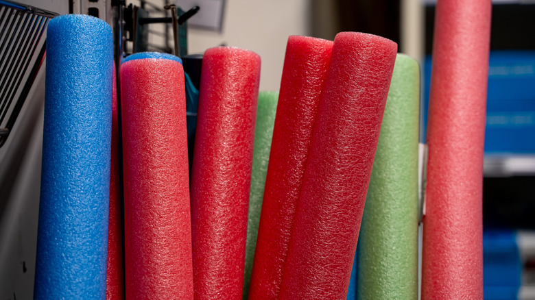 Pool noodles stored upright.