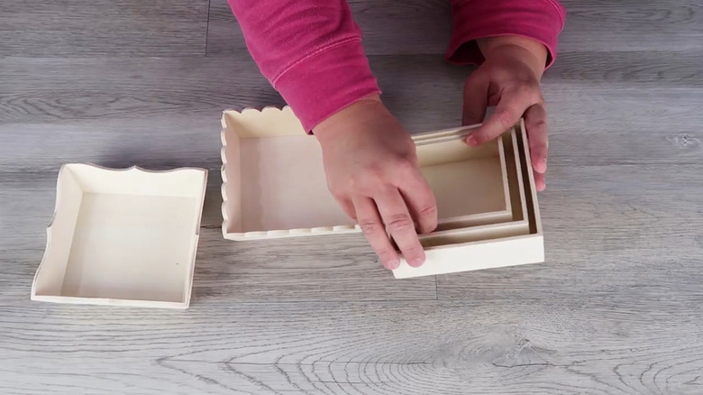 Creator preparing wooden boxes from Dollar Tree to make home decor