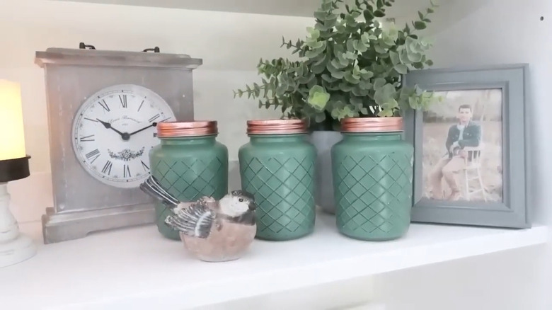 Green painted Dollar Tree jars on shelf