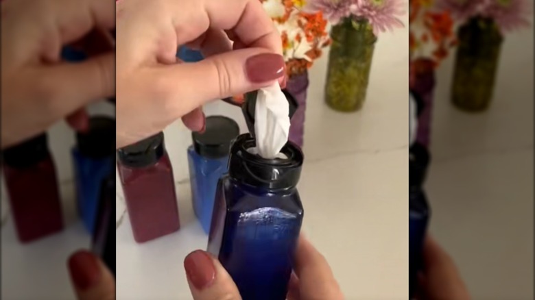 Person pulling a baby wipe out of a spice jar