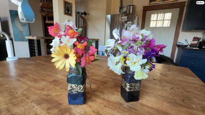 Two small flower arrangements made in spice jars