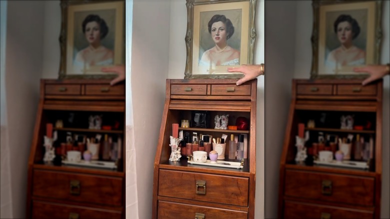 A Drexel roll-top cabinet being used to store and organize makeup