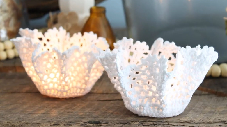 Votive candle holders made from stiffened doilies