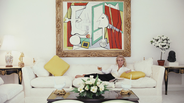 Woman lounging on couch in 1980s living room