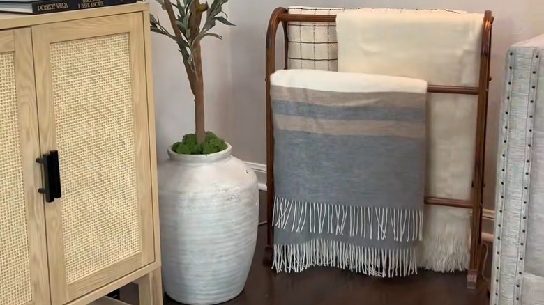 Quilt rack turned into blanket storage piece in living room