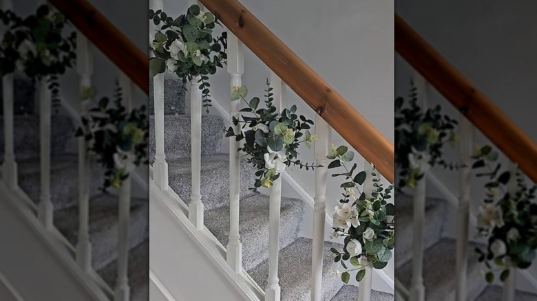 Staircase spindles decorated using pool noodles and artificial flowers