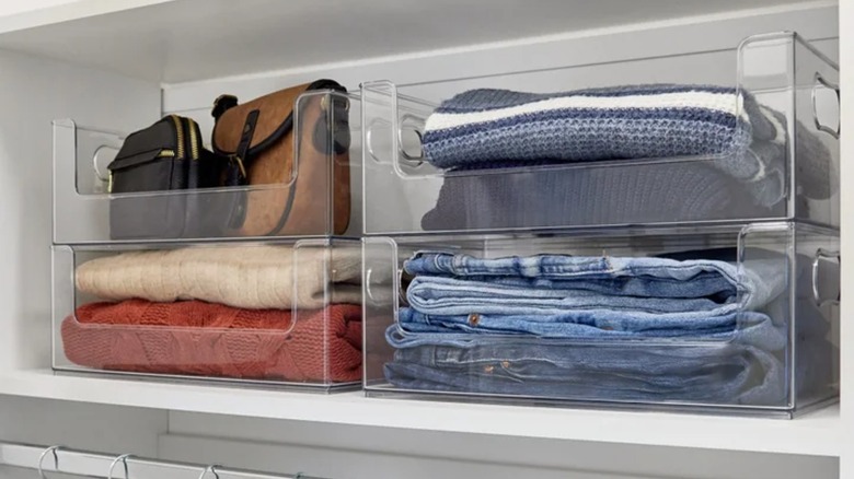 Clothes and accessories are stored in clear closet bins