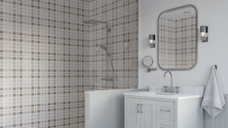 a shower with plaid tiles in a white bathroom