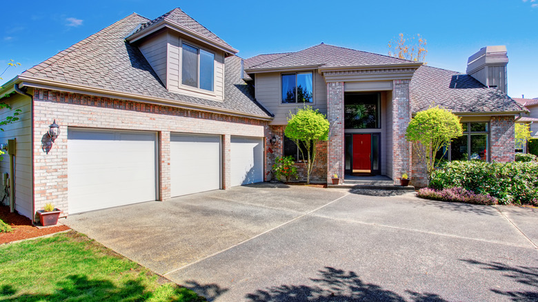 A modern house with a wide concrete driveway