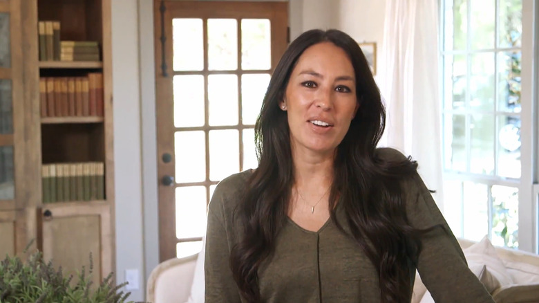 Joanna Gaines smiling in a home she remodeled