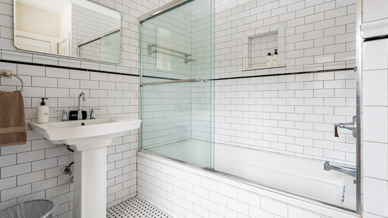 a classic shower with subway tile