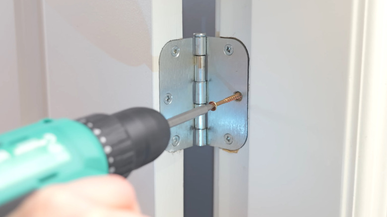 Driving a single longer screw into a door hinge