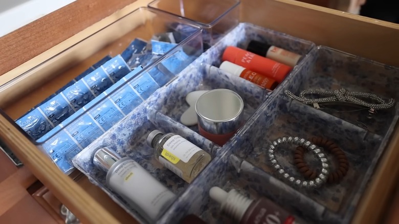 Stylish plastic organizers in a bathroom drawer holding items