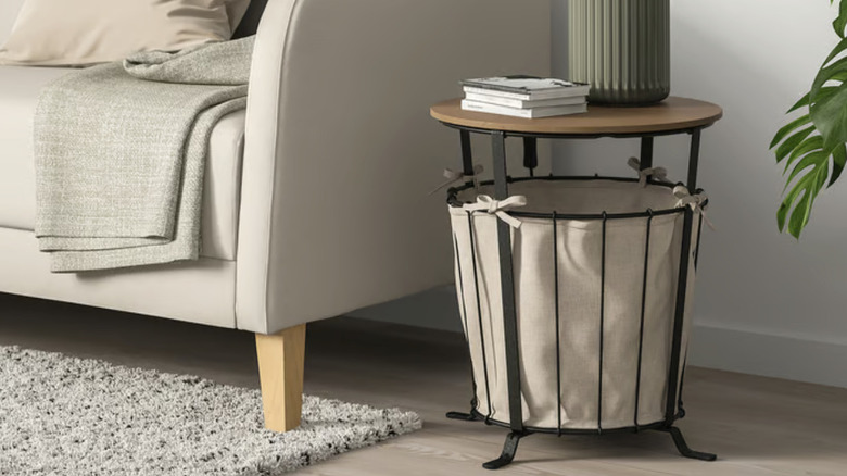 IKEA ÄNGESBYN end table next to a couch with a blanket on it
