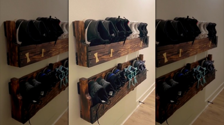Wood pallet hanging shoe storage mounted to a beige wall