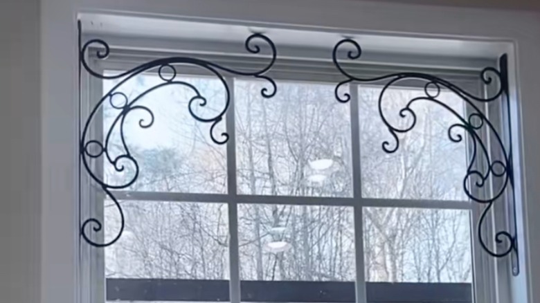 Ornate plant hanging hooks mounted in kitchen window
