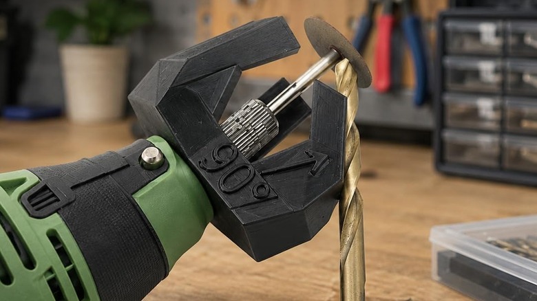 Black SplashNColor drill bit sharpener guide on a green rotary tool, sharpening a gold drill bit
