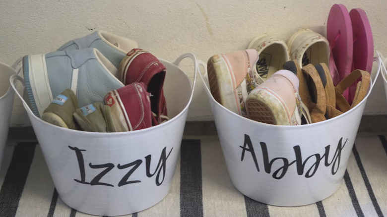 buckets with labels on them and shoes inside