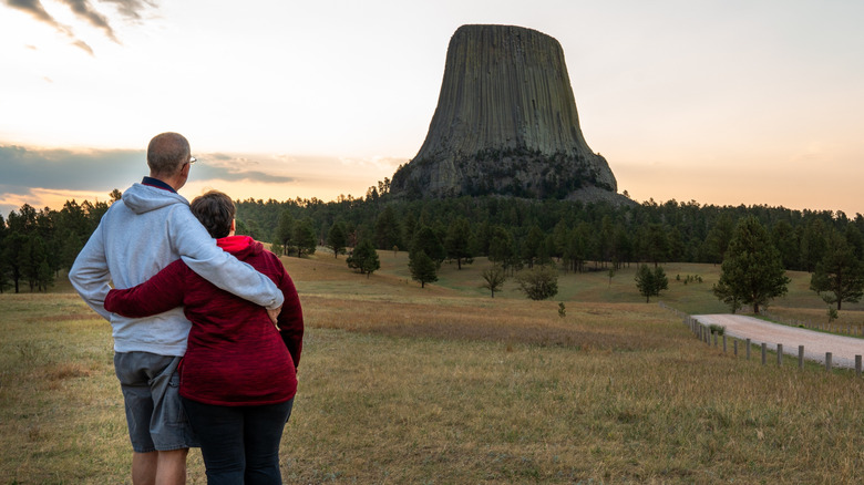A couple viewing Devils Tower National Monument in Wyoming