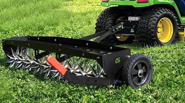 Suchtale spike aerator attached to a riding lawn mower