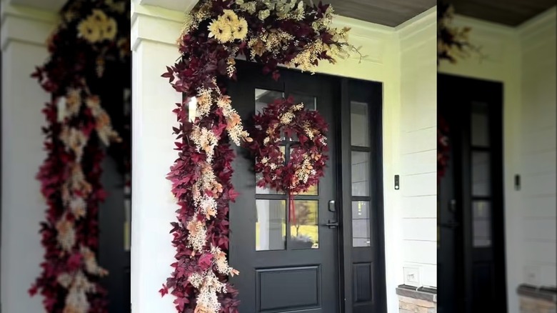 Front door dressed up with burgundy fall decor