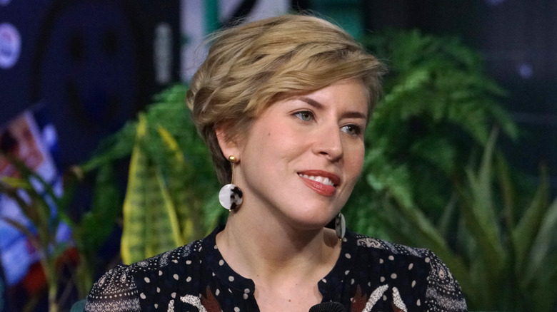 Erin Napier interviewing in front of green plant