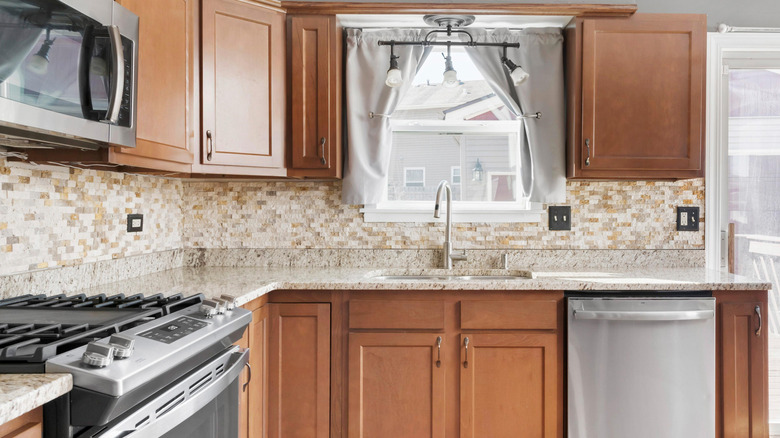 Kitchen with outdated brown cabinets