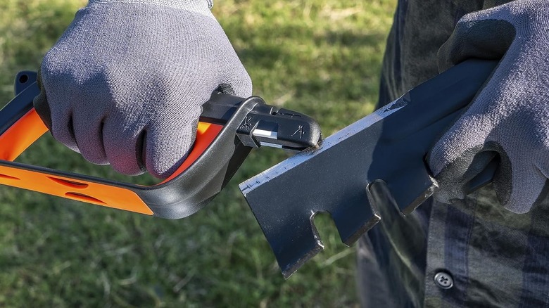 someone sharpening mower blades with the SHARPAL 103N all-in-1 blade sharpener