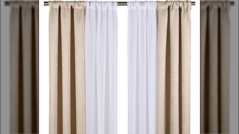 Aldi's beige blackout curtains on a rod with sheer white curtains in the center
