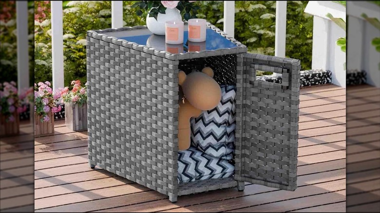 Wicker end table for outdoor seating area with an opening door