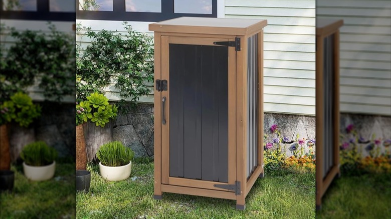Small wood and metal cabinet outside a house