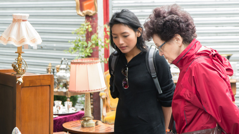 Two women browsing a thrift store