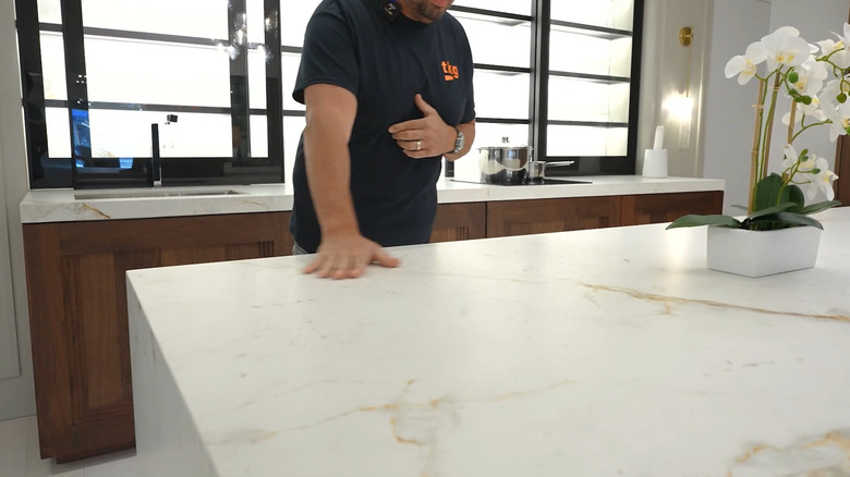 Person showing a sintered stone countertop