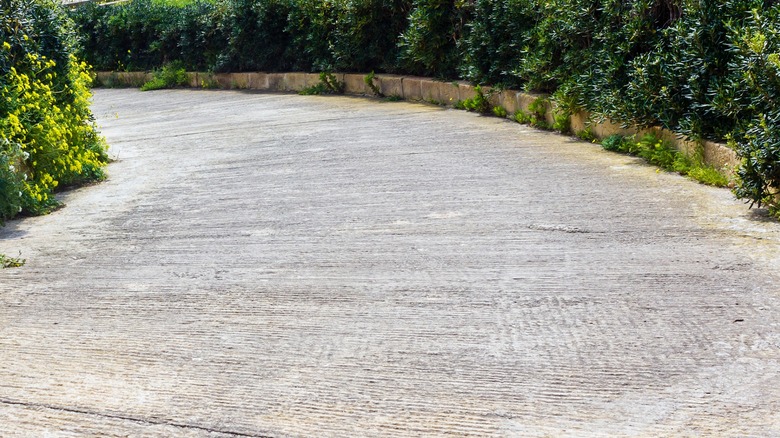 Rough concrete driveway with deep scratches