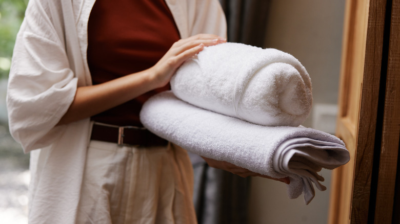 Person holding folded bath towels