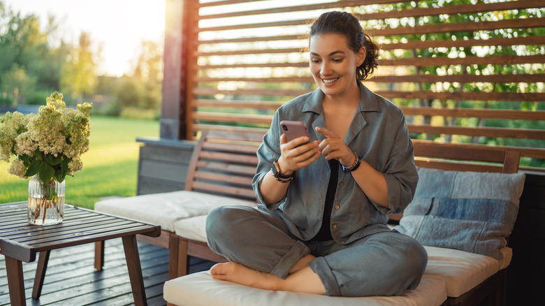 Woman sitting on a neat, organized patio