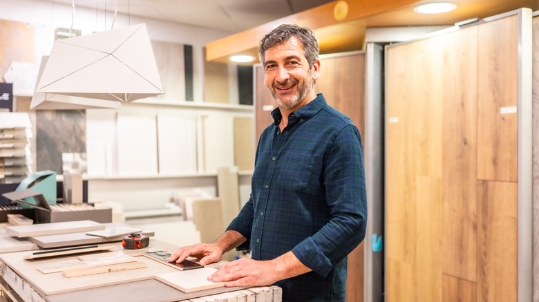 A person looking smiling in a store with home finishing materials