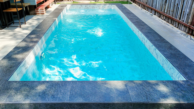 Small cocktail pool in a backyard near a patio