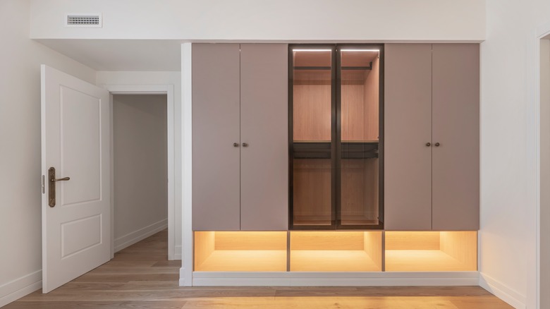 A traditional built-in wardrobe with gray doors